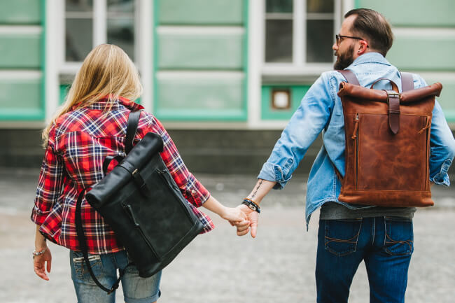 A couple with two handmade leather backpacks from KrukGarage
